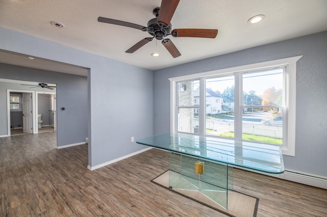 interior space featuring ceiling fan and dark hardwood / wood-style flooring