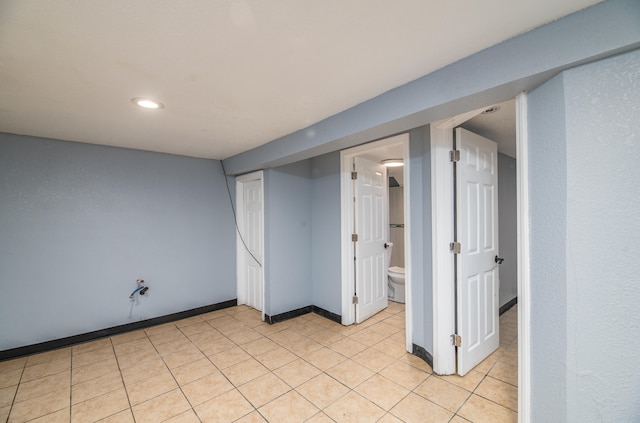 basement featuring light tile patterned floors