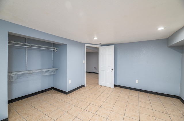 unfurnished bedroom featuring a closet and light tile patterned floors