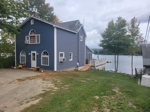 900 Brewer Lake Rd, Orrington, ME 04474 - view of side of home featuring a yard, cooling unit, and a shingled roof