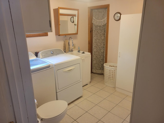 900 Brewer Lake Rd, Orrington, ME 04474 - washroom with washer and clothes dryer and light tile patterned flooring