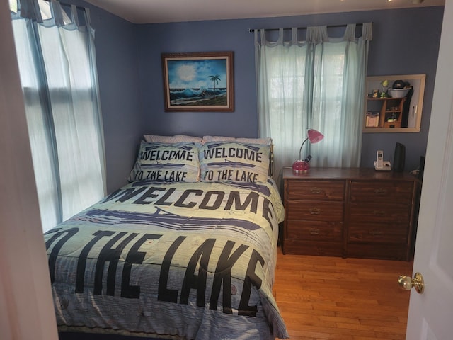 900 Brewer Lake Rd, Orrington, ME 04474 - bedroom with multiple windows and wood finished floors