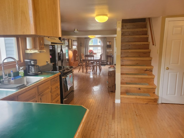 900 Brewer Lake Rd, Orrington, ME 04474 - kitchen featuring appliances with stainless steel finishes, custom range hood, and light wood-style flooring