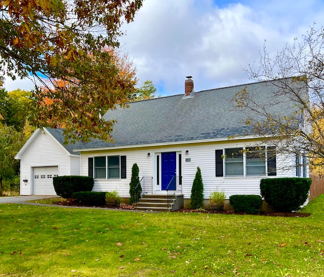 cape cod home featuring a garage and a front lawn