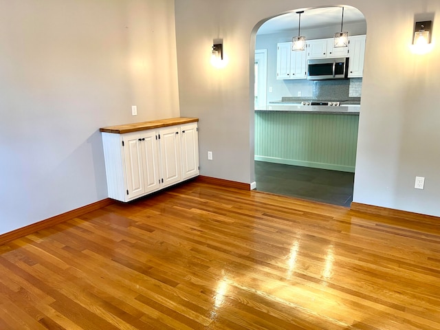 empty room with light hardwood / wood-style flooring