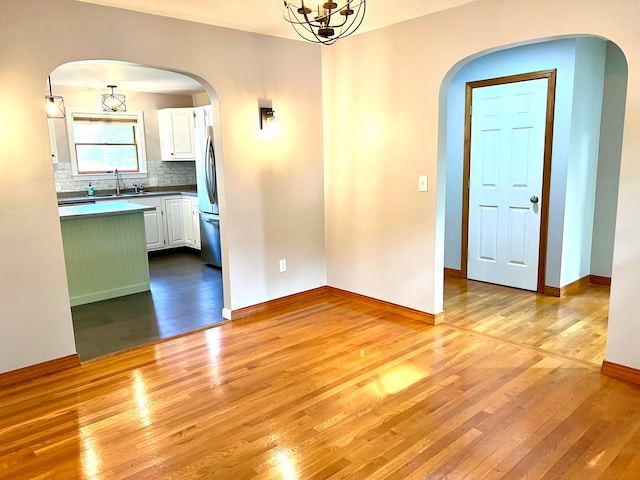 interior space with sink, a chandelier, and light hardwood / wood-style floors