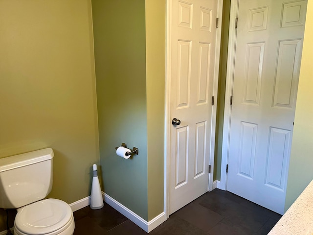 bathroom with toilet and tile patterned floors