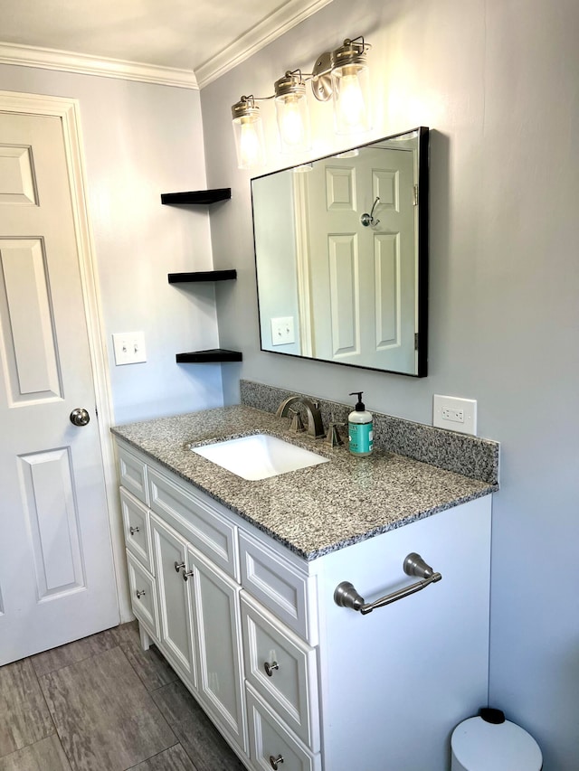 bathroom featuring vanity, hardwood / wood-style floors, and ornamental molding