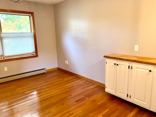 spare room with light hardwood / wood-style floors and a baseboard radiator