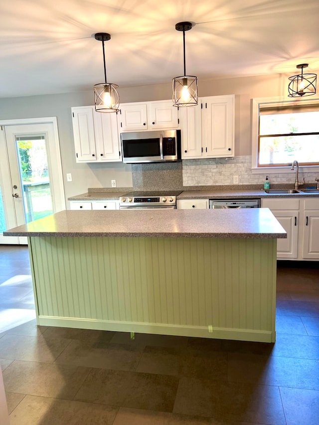 kitchen featuring a wealth of natural light, sink, white cabinets, and stainless steel appliances