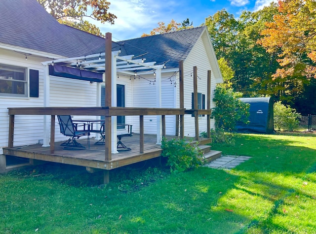 exterior space with a pergola, a deck, and a lawn