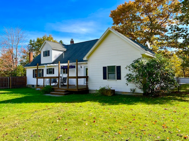 rear view of property with a yard and a deck