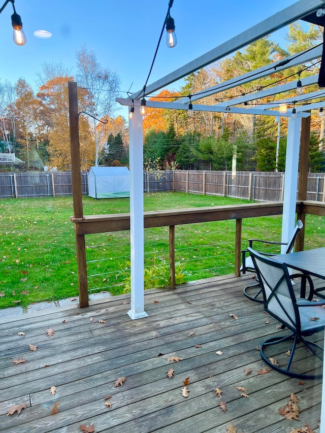 wooden deck featuring a lawn