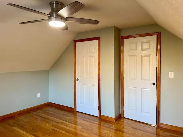 additional living space featuring light hardwood / wood-style flooring, ceiling fan, and vaulted ceiling