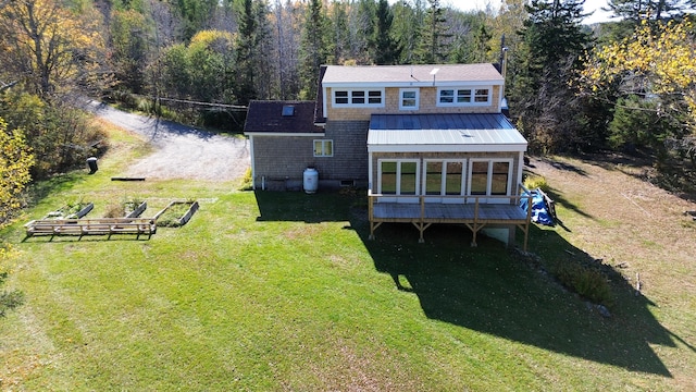 rear view of property with a yard