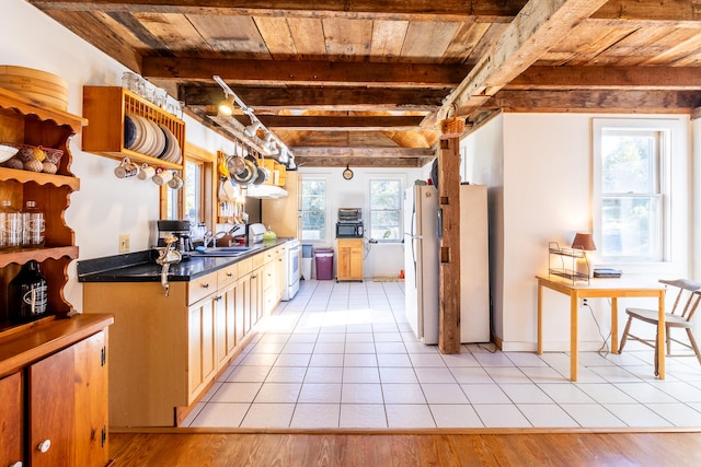 kitchen with beam ceiling, light hardwood / wood-style flooring, wood ceiling, and white appliances