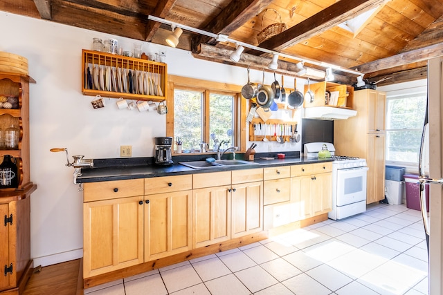 kitchen with sink, wood ceiling, light tile patterned floors, and gas range gas stove