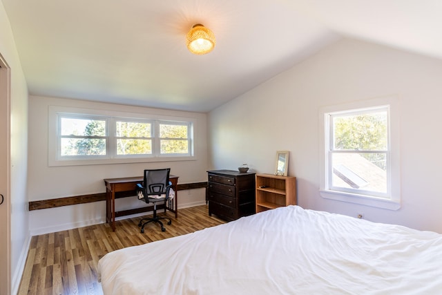 bedroom featuring lofted ceiling and wood-type flooring