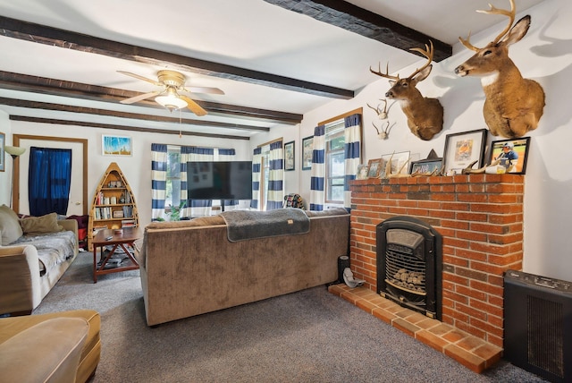 carpeted living room featuring beam ceiling, a fireplace, and ceiling fan