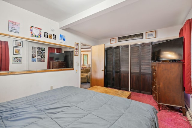 bedroom featuring a closet, beamed ceiling, and carpet