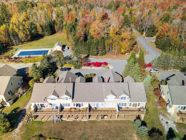 drone / aerial view featuring a view of trees and a residential view
