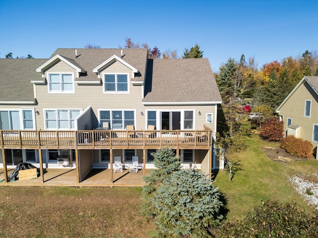 back of house with a yard, a patio, a shingled roof, and a deck