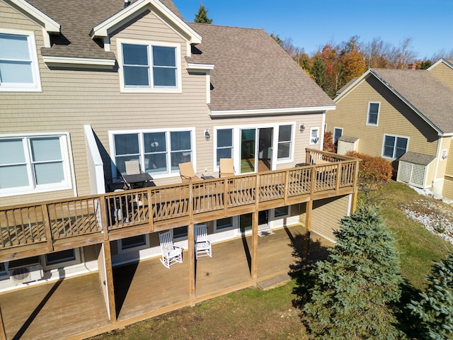 back of house featuring a wooden deck, a patio, and a shingled roof