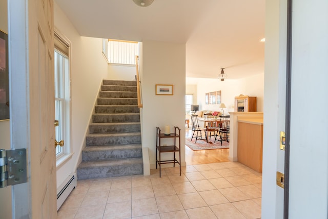 staircase with tile patterned flooring and baseboard heating