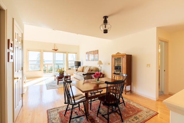 dining area with light wood-style flooring