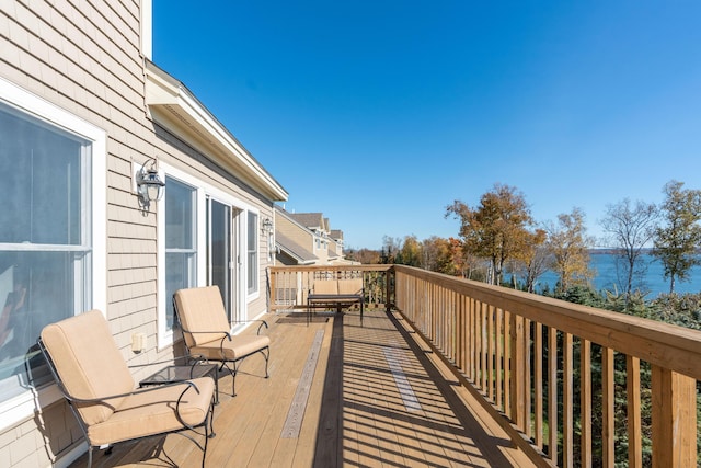 balcony featuring a deck with water view