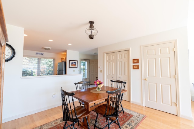 dining space featuring light wood-style floors, recessed lighting, and baseboards