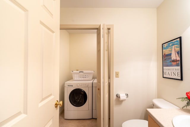 bathroom with washer / dryer, tile patterned floors, vanity, and toilet