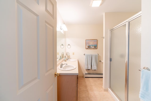 bathroom featuring double vanity, baseboard heating, a shower stall, a sink, and tile patterned floors