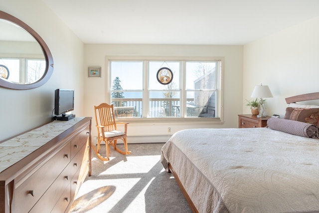 carpeted bedroom featuring a baseboard heating unit
