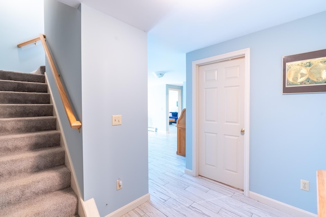 stairway with baseboards and wood finished floors