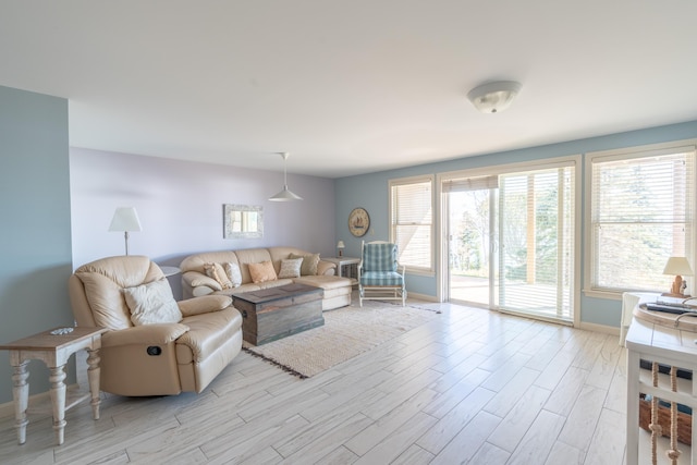 living area with light wood-style floors and baseboards