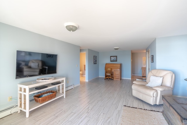 living room with baseboards, a baseboard heating unit, and wood finished floors