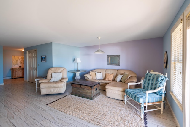 living area with baseboards and wood finished floors