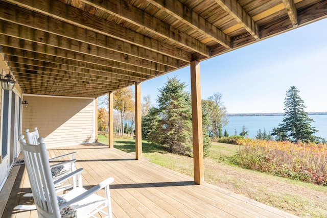 deck featuring a water view and a yard