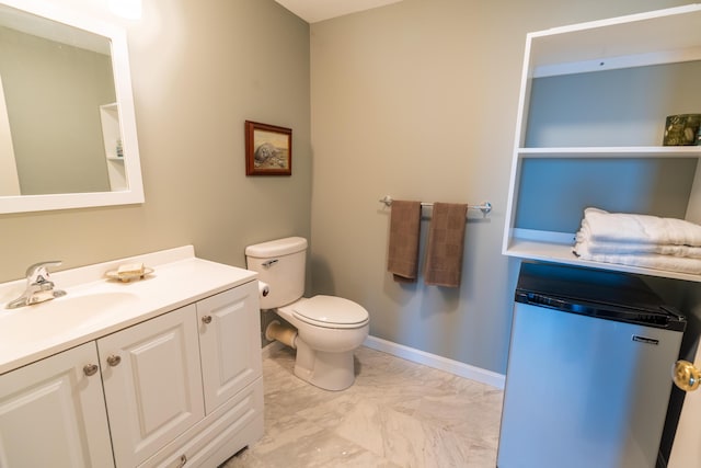 bathroom featuring vanity, marble finish floor, and toilet