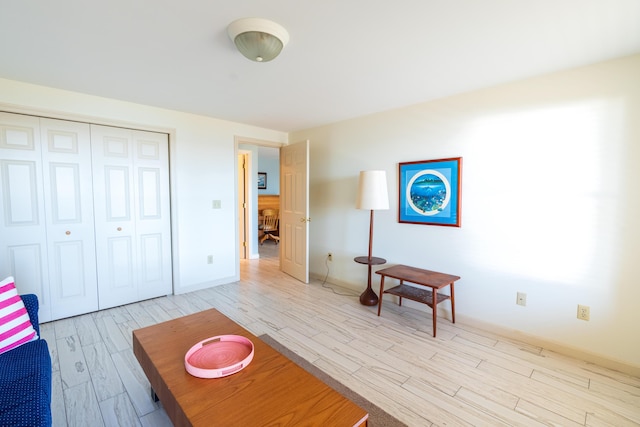 bedroom featuring baseboards, a closet, and wood finished floors