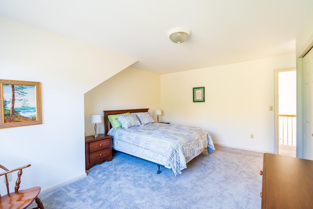 bedroom with baseboards and light colored carpet