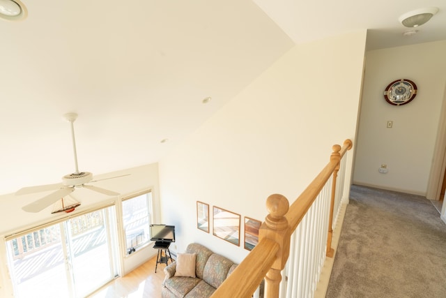 interior space with an upstairs landing and lofted ceiling