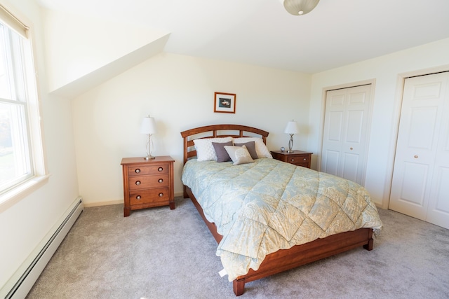 bedroom with carpet flooring, multiple closets, and a baseboard radiator