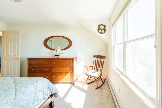 bedroom with light colored carpet and a baseboard heating unit
