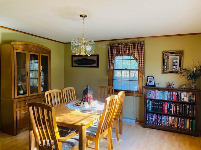 dining room with baseboard heating, crown molding, light hardwood / wood-style flooring, and an inviting chandelier