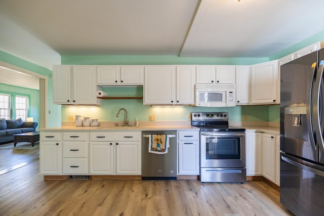 kitchen featuring light hardwood / wood-style flooring, white cabinetry, stainless steel appliances, and sink