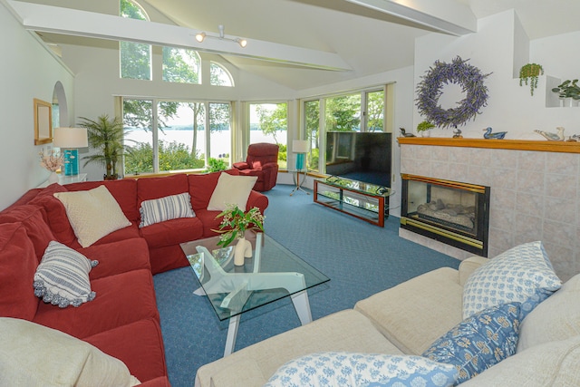 living room featuring beam ceiling, high vaulted ceiling, carpet, and a fireplace