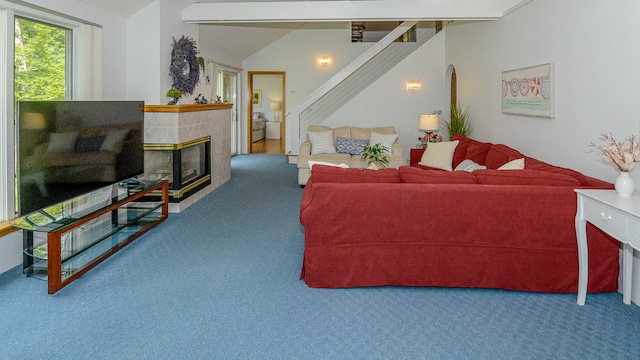 living room featuring lofted ceiling, a fireplace, and carpet floors