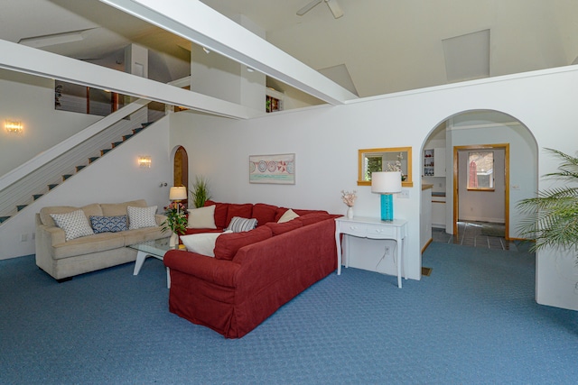 living room with carpet floors and high vaulted ceiling